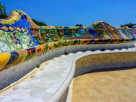 Colorful ceramic bench at the Parc Guell designed by Antoni Gaudi, Barcelona, Spain.