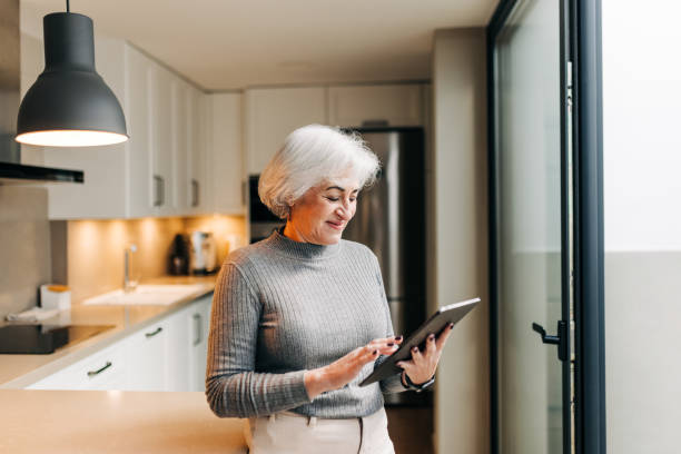 istock Mature woman using a digital tablet at home 1396450464