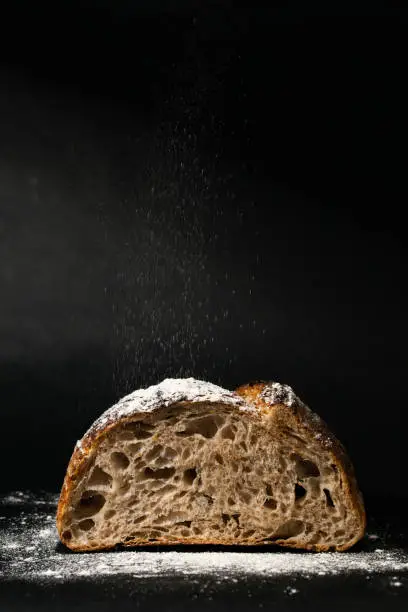 Sourdough sliced bread with big pores and falling flour