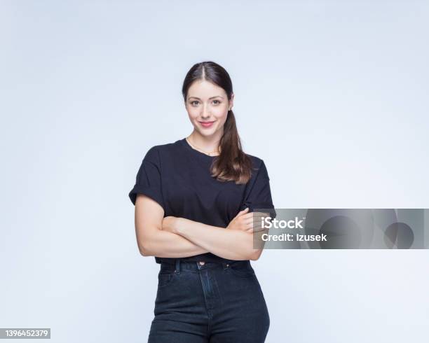 Woman With Arms Crossed Against White Background Stock Photo - Download Image Now - T-Shirt, Women, One Woman Only