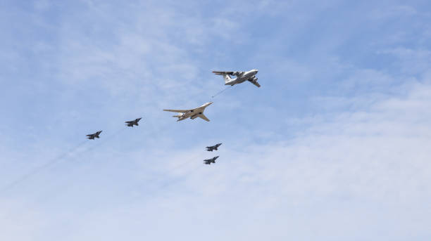 Simulation of refueling in the air. IL-78 tanker aircraft and Tu-160 strategic bomber. Four Mig-31BM fighters accompany Moscow, Russia, May 2022: Simulation of refueling in the air. IL-78 tanker aircraft and Tu-160 strategic bomber. Four Mig-31BM fighters accompany. Aircrafts participating in the rehearsal of parade. tu160 stock pictures, royalty-free photos & images
