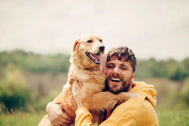 Photo of Guy and his dog, golden retriever, nature