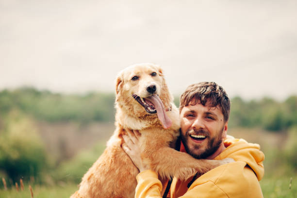istock Guy and his dog, golden retriever, nature 1396454976
