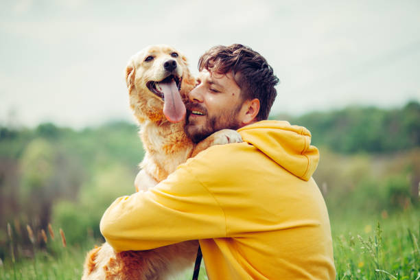 istock Guy and his dog, golden retriever, nature 1396455057