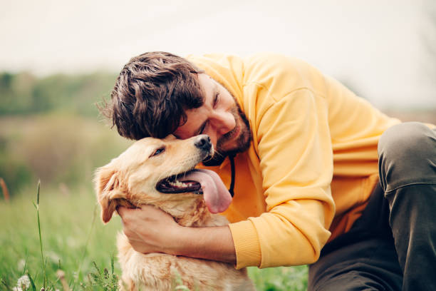 istock Guy and his dog, golden retriever, nature 1396455059