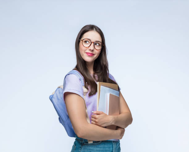 istock Thoughtful girl with backpack and books 1396455072