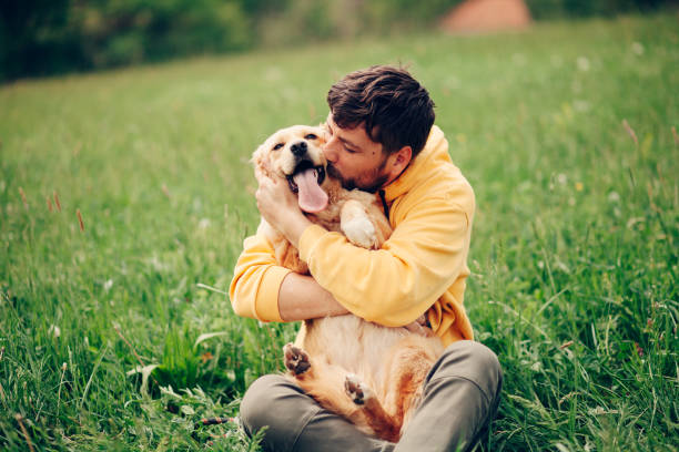 istock Guy and his dog, golden retriever, nature 1396455160