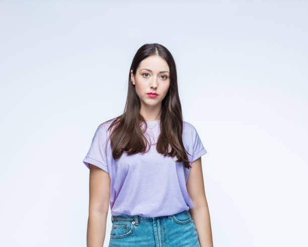 istock Woman in t-shirt with blank expression 1396455182