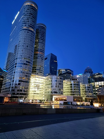 The modern City La Défense (Courbevoie) with its large office Builidings. The image was captured during springtime at dusk and shows the Cœur Défense (161m built 2001) and other Skyscrapers.