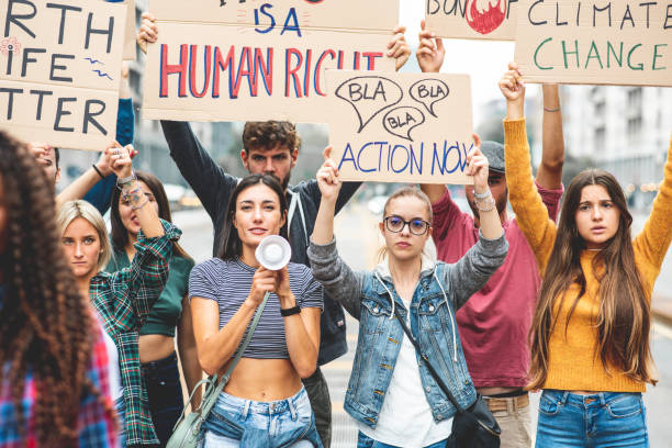 istock Group of multiethnic people making protest about climate change, public demonstration on the street against global warming and pollution. 1396457176