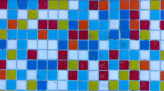 background texture of a mosaic of small multi-colored square ceramic tiles.