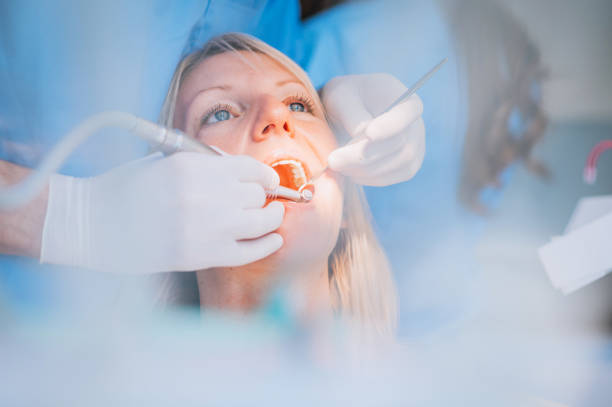 close-up of a dental drill procedure at dentist - dentists chair fotos imagens e fotografias de stock