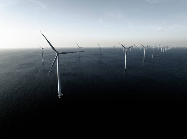 istock Wind turbines in an offshore wind park producing electricity 1396460811