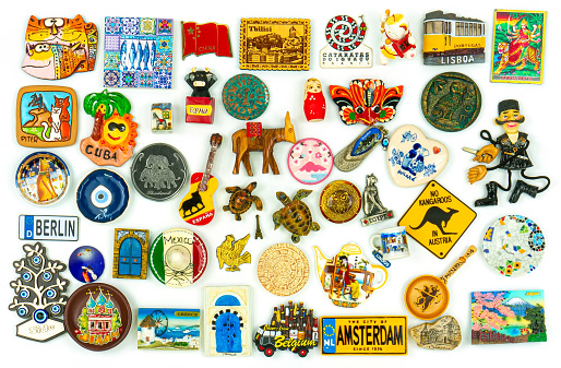 Souvenirs From Around The World On A White Background. Fridge magnets. Landscape orientation.
