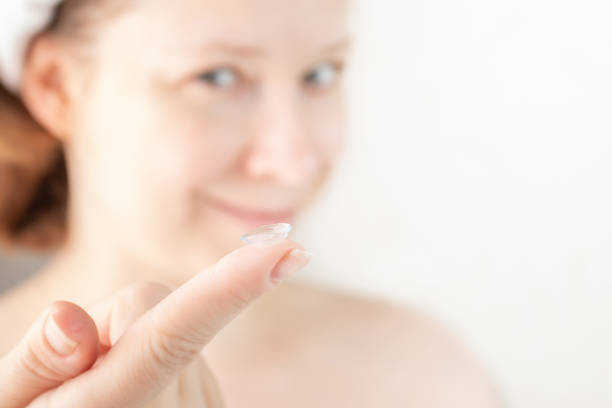 istock woman putting soft hydrogel contact lenses on her eyes on white background 1396463817