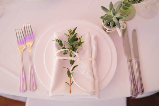 istock Table setting at the wedding reception. Floral compositions with name card on a vintage plate on a decorated table. 1396464108