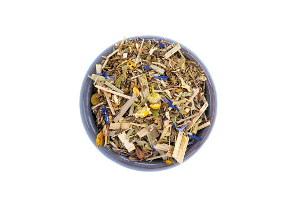 istock Small blue bowl with dry herbs tea on a white isolated background,top view. 1396464644