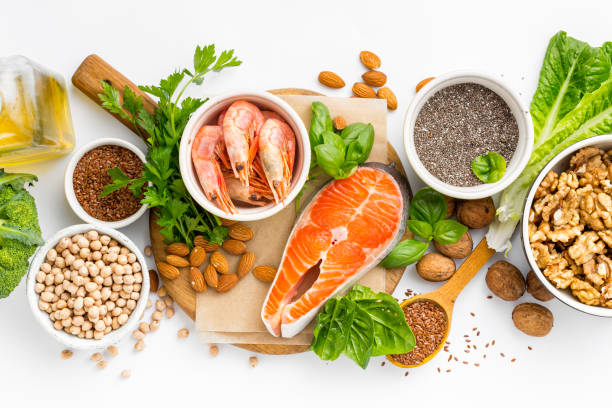 foods high in fatty acids including vegetables, seafood, nut and seeds on white background top view. food sources of omega 3 and omega 6 concept - nutritional supplement salmon food flax imagens e fotografias de stock
