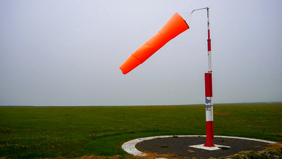 Windsock on a pole near the airport runway