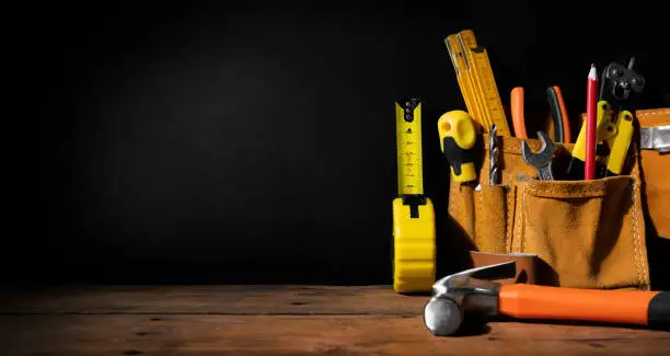 Photo of home improvement - construction tools on black background with copy space. banner
