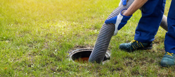 man pumping out house septic tank. drain and sewage cleaning service. copy space stock photo