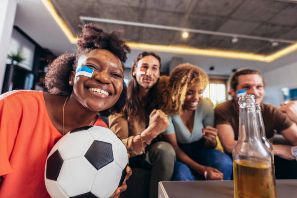 istock Young group watching sports on television and cheering. 1396466606