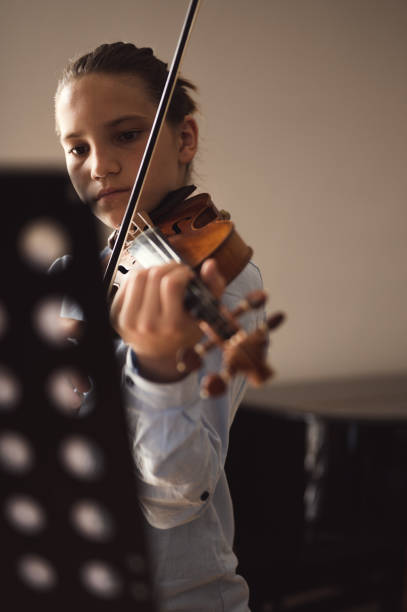 istock Teenage violin student practicing at school