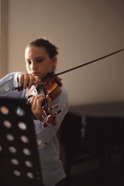 istock Teenage violin student practicing at school