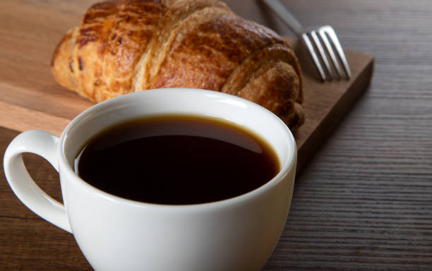 istock Croissant with a cup of full coffee 1396469171
