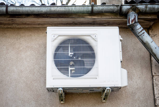istock Air source heat pump, outdoor unit attached to the house wall 1396469321