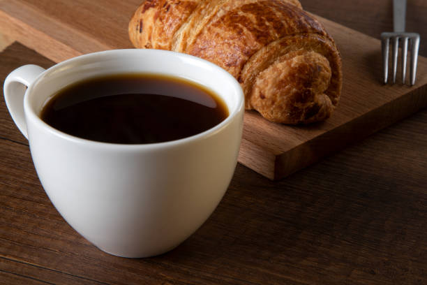 istock Croissant with a cup of full coffee 1396470539