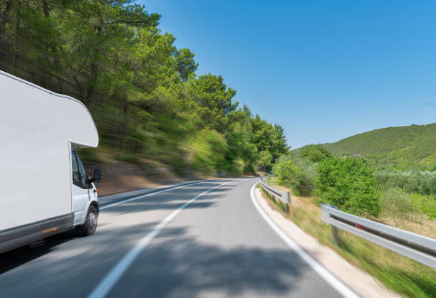 istock Camper trailer on Highway. road trip in motorhome 1396473562