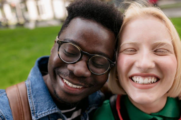 istock Happy diverse love couple hanging out on a sidewalk 1396475141