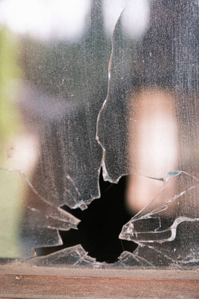 istock Close-up of a broken glass with a hole. 1396475208