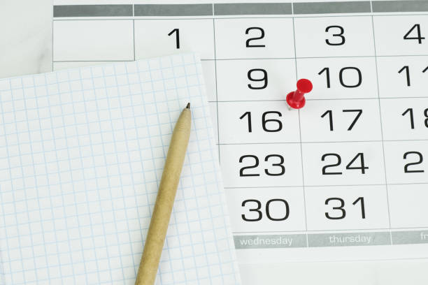 istock Ballpoint pen, notepad and calendar with date marked 1396476826