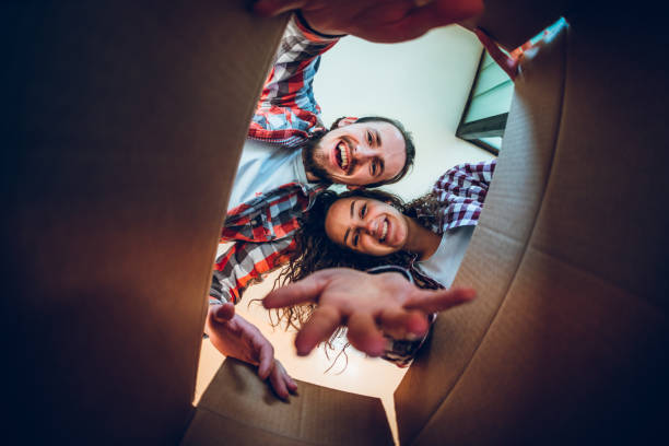 istock Happy young couple looking inside the box 1396477292