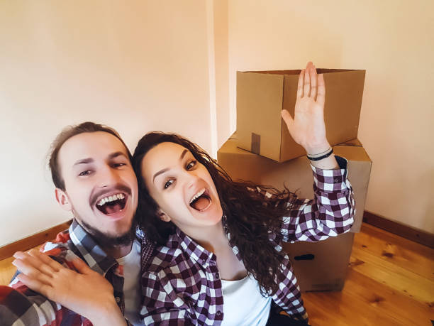 istock Couple making selfie while moving in new home 1396477616