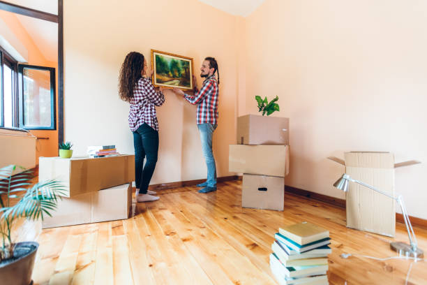 istock Excited couple hanging picture on wall 1396478409