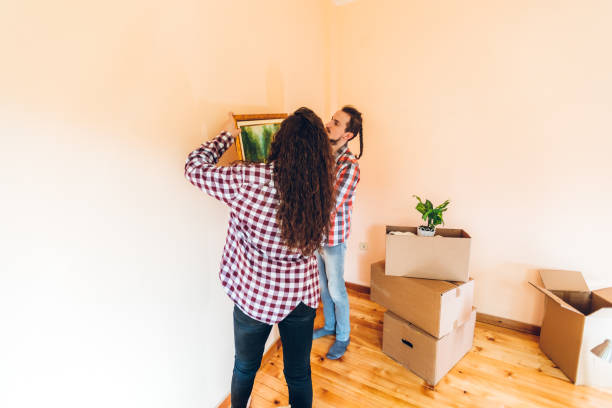 istock Excited couple hanging picture on wall 1396478463
