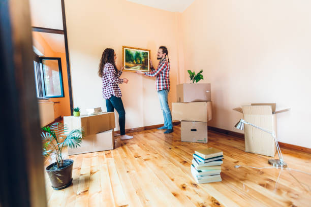 istock Excited couple hanging picture on wall 1396478511