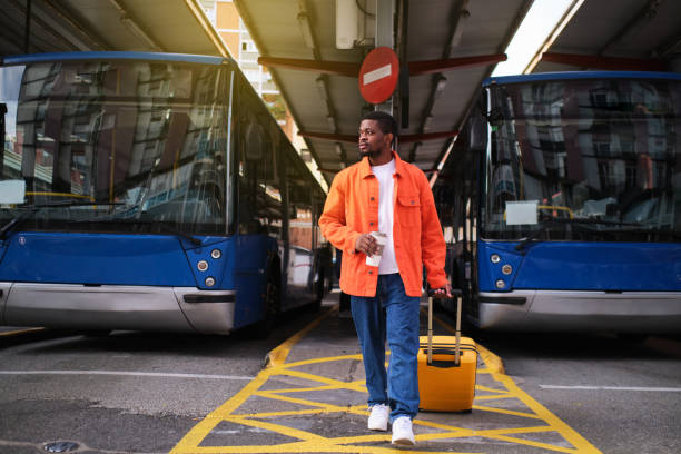 istock A young man returning from a trip with his suitcase and holding a cup of coffee 1396479185