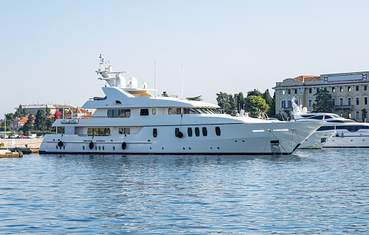 White yacht at the marina in the evening.