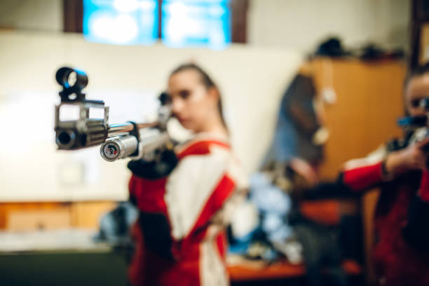 Two young caucasian women having sport shooter training.