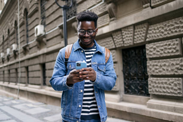istock Young man using a smart phone outdoors 1396480704