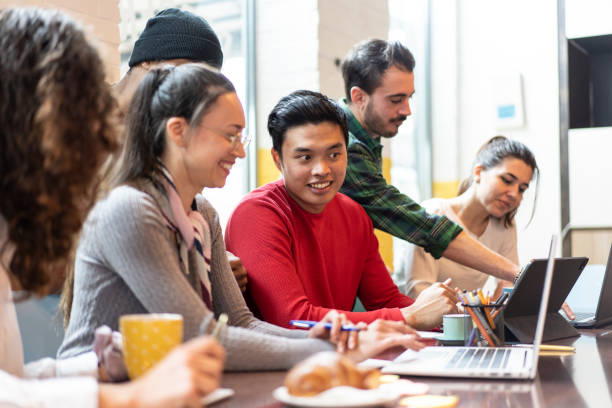 istock Young co-workers multiethnic team planning a new startup - Happy people working on a new project in creative coworking office - Marketing concept - Bright filter with focus on asian man face 1396482342