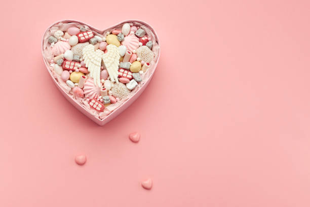 istock Box with sweets on a pink background as a blank for a greeting card 1396482870