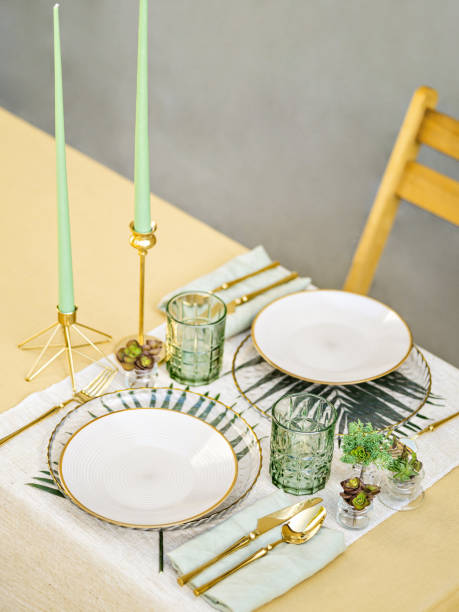istock Beautiful simple table setting with linen napkins, gold cutlery and floristic. Table served for romantic dinner or festive event. Outdoor catering and dining. 1396484652