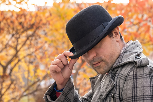 Man in black hat outdoors in the park. Urban lifestyle.