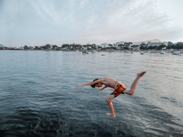 istock Boy jumping into the sea on a beach in Majorca 1396489256