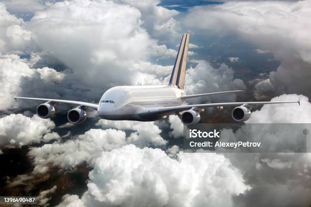 Passenger Double Decker Plane Fly High In The Cloudy Sky Front View Stock Photo - Download Image Now